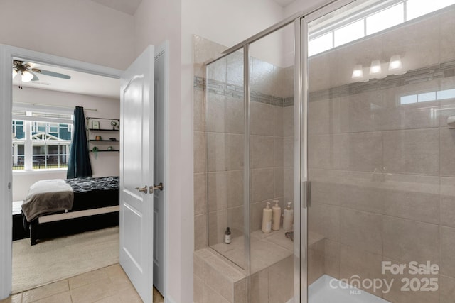 bathroom with tile patterned floors, ceiling fan, a shower stall, and connected bathroom