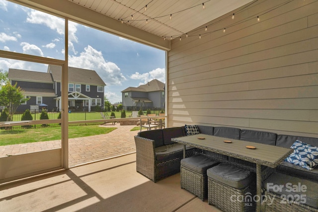 view of patio / terrace featuring an outdoor living space, fence, and a residential view