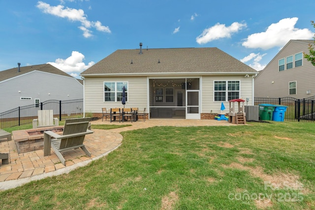 rear view of property featuring a fenced backyard, a patio area, a lawn, an outdoor fire pit, and central air condition unit