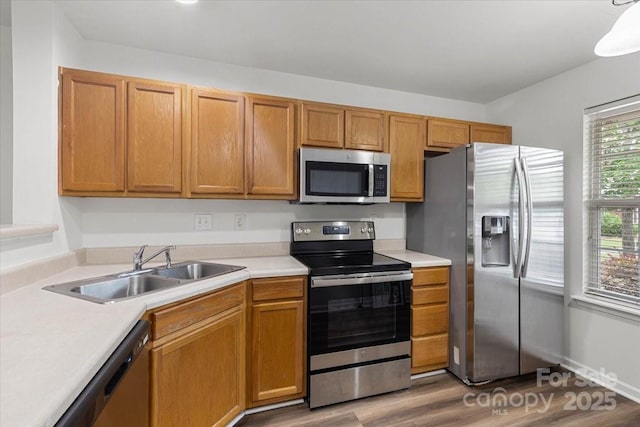 13660 Meade Glen Ct, Charlotte, NC 28273 - kitchen with stainless steel appliances, a sink, light countertops, and wood finished floors