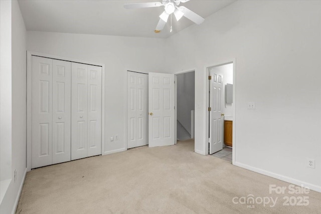 13660 Meade Glen Ct, Charlotte, NC 28273 - unfurnished bedroom featuring light carpet, two closets, baseboards, ensuite bathroom, and high vaulted ceiling