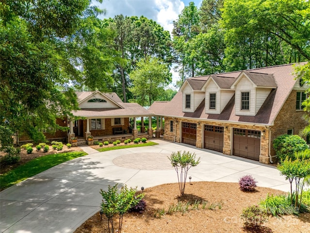 16317 Terry Ln, Huntersville, NC 28078 - cape cod house featuring concrete driveway, a porch, and stone siding