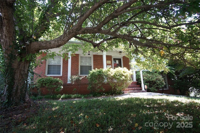 obstructed view of property featuring brick siding