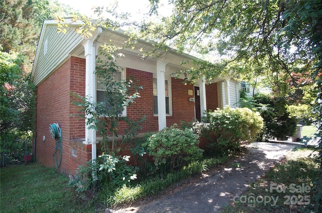 view of side of home featuring brick siding