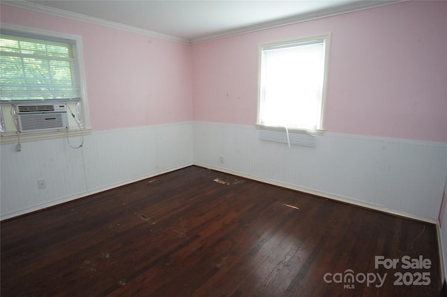 unfurnished room featuring plenty of natural light, wainscoting, wood finished floors, and cooling unit