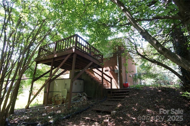view of side of home with a wooden deck and stairway