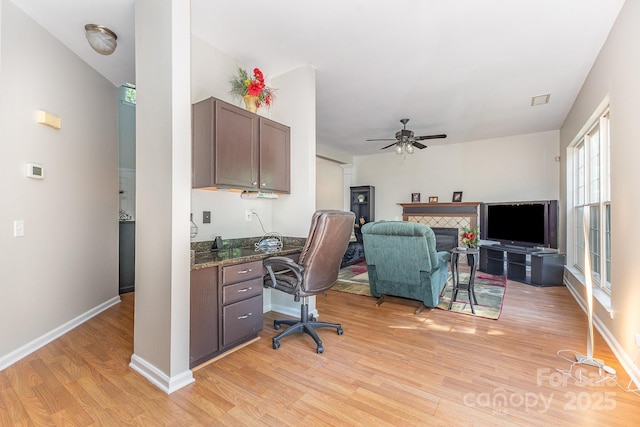 815 Clearbrook Rd, Matthews, NC 28105 - office space featuring ceiling fan, visible vents, light wood-type flooring, a tile fireplace, and baseboards