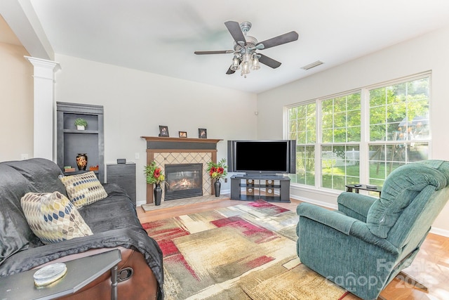815 Clearbrook Rd, Matthews, NC 28105 - living area with a fireplace, a ceiling fan, decorative columns, wood finished floors, and visible vents