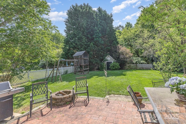 815 Clearbrook Rd, Matthews, NC 28105 - view of patio / terrace with grilling area, a fenced backyard, a playground, and an outdoor fire pit