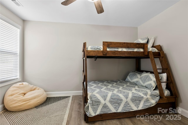 106 Dalton St, Black Mountain, NC 28711 - bedroom featuring baseboards, multiple windows, wood finished floors, and ceiling fan