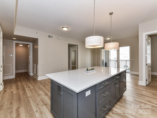 4625 Piedmont Row Dr Unit 410, Charlotte, NC 28210 - kitchen featuring gray cabinets, baseboards, and light wood-style floors