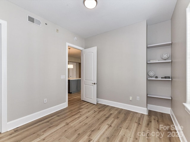 4625 Piedmont Row Dr Unit 410, Charlotte, NC 28210 - unfurnished bedroom with light wood finished floors and baseboards