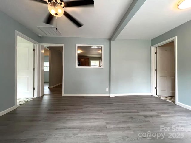 spare room with baseboards, a ceiling fan, and wood finished floors