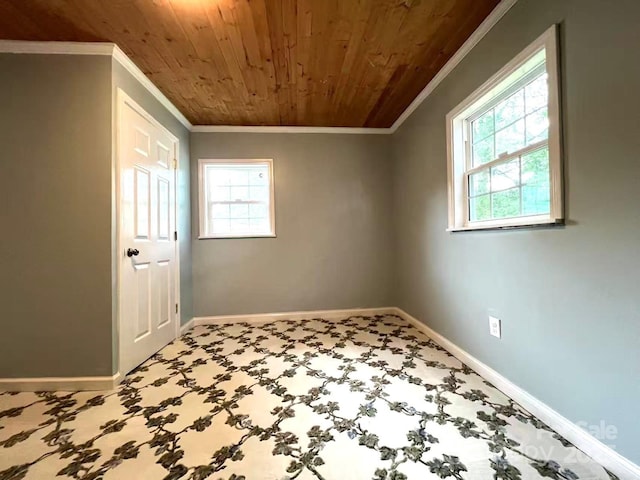 interior space featuring carpet flooring, baseboards, ornamental molding, and wood ceiling
