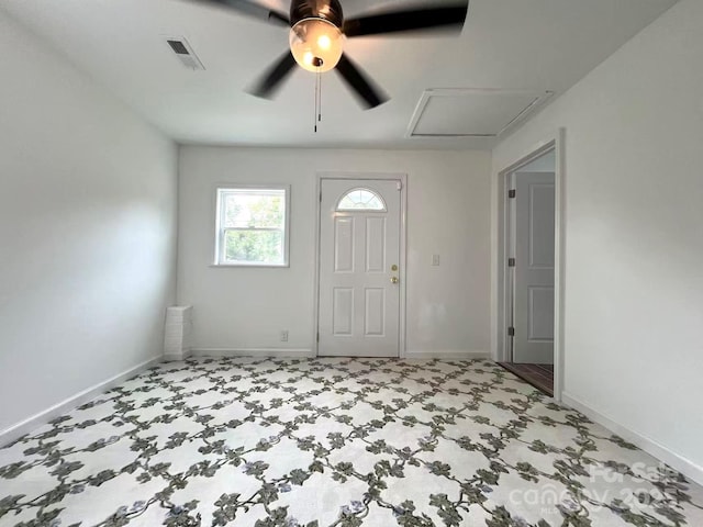 entryway featuring baseboards, ceiling fan, and visible vents