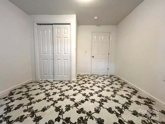 bedroom featuring baseboards and a closet