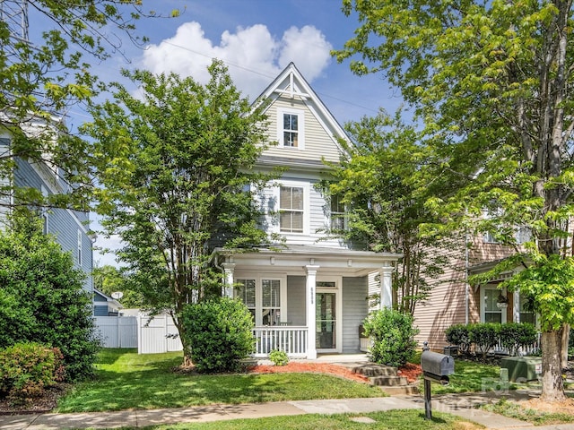 6909 Dunton St, Huntersville, NC 28078 - victorian house featuring fence, a porch, and a front yard