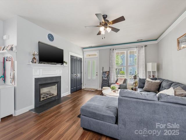 6909 Dunton St, Huntersville, NC 28078 - living area with visible vents, a glass covered fireplace, baseboards, a ceiling fan, and dark wood finished floors