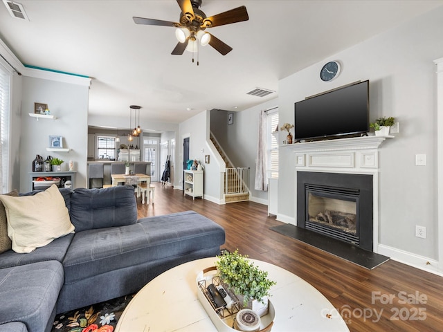 6909 Dunton St, Huntersville, NC 28078 - living room featuring ceiling fan, dark wood-style floors, stairs, and visible vents