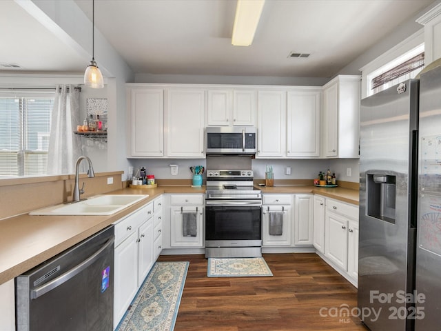 6909 Dunton St, Huntersville, NC 28078 - kitchen featuring white cabinets, appliances with stainless steel finishes, a sink, and visible vents