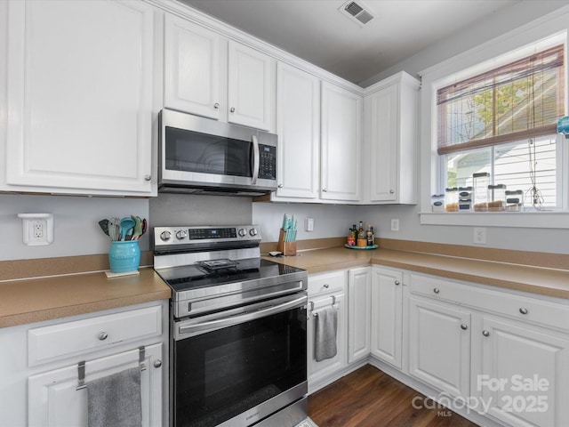 6909 Dunton St, Huntersville, NC 28078 - kitchen featuring light countertops, stainless steel appliances, white cabinetry, and visible vents