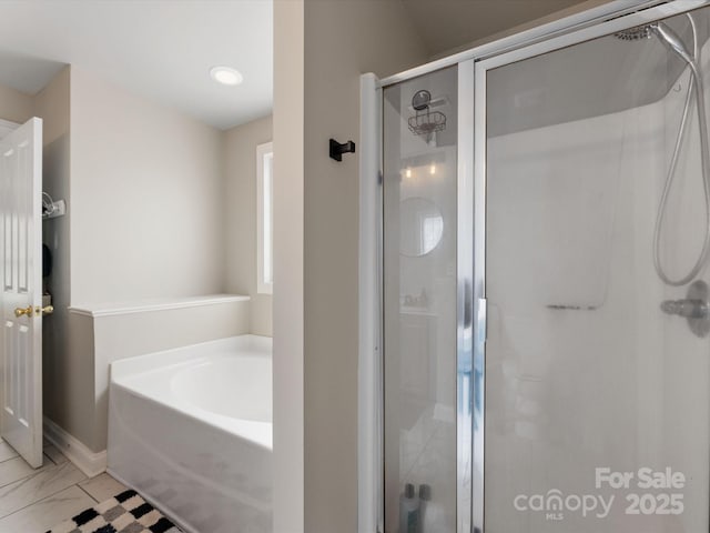 6909 Dunton St, Huntersville, NC 28078 - full bathroom with baseboards, a stall shower, a garden tub, and marble finish floor