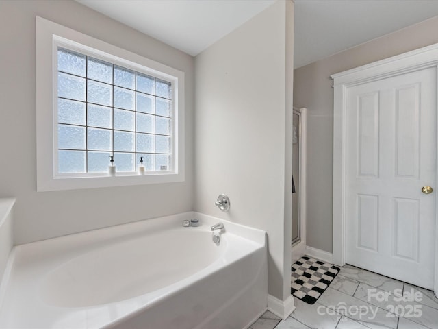 6909 Dunton St, Huntersville, NC 28078 - bathroom with baseboards, a shower stall, and a garden tub