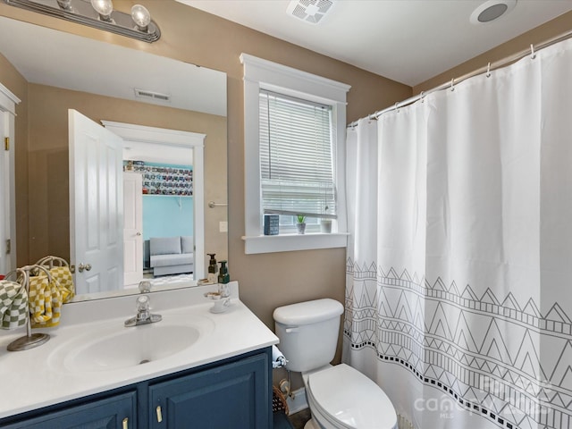 6909 Dunton St, Huntersville, NC 28078 - bathroom featuring toilet, visible vents, curtained shower, and vanity