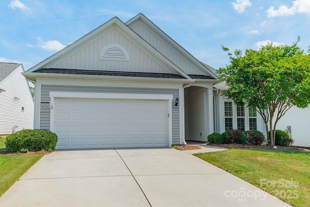 view of front of home with a garage, a front lawn, board and batten siding, and concrete driveway