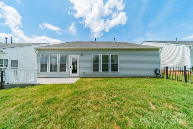 back of house with a lawn, fence, and a patio area