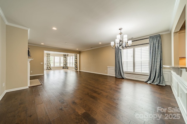unfurnished living room with an inviting chandelier, crown molding, and dark wood finished floors