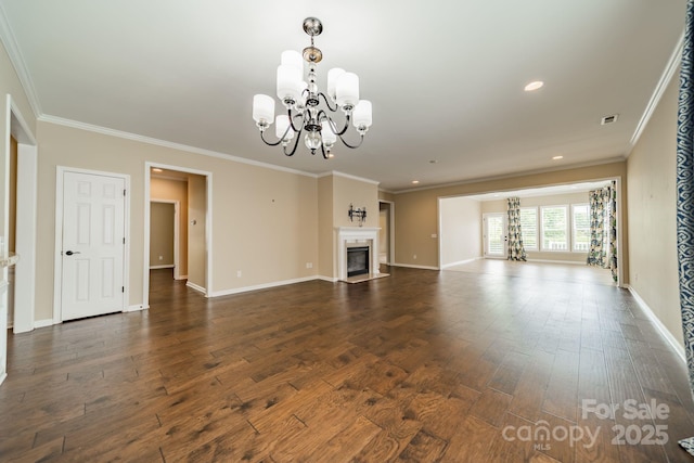 unfurnished living room with a fireplace with flush hearth, dark wood finished floors, baseboards, a notable chandelier, and ornamental molding