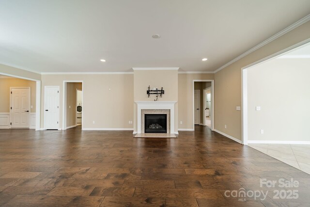 unfurnished living room featuring crown molding, recessed lighting, a fireplace with flush hearth, and wood finished floors