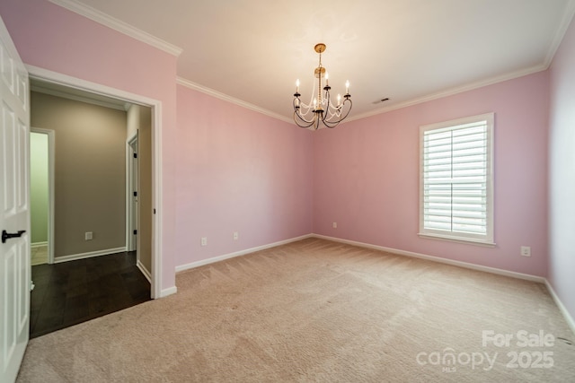 carpeted empty room with an inviting chandelier, baseboards, and crown molding