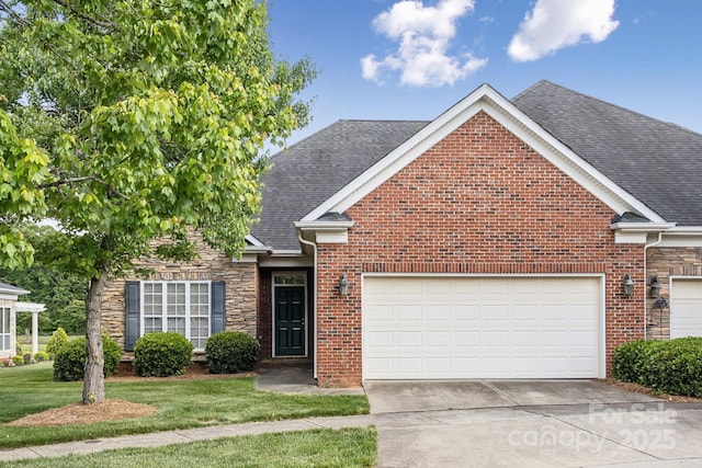 view of front of house with a garage, a front yard, brick siding, a shingled roof, and driveway
