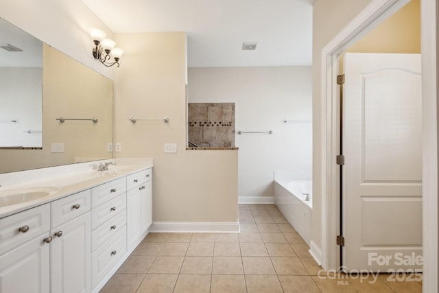 bathroom with a garden tub, double vanity, baseboards, tile patterned floors, and a sink