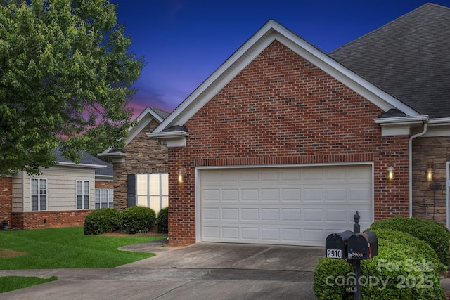 view of front of home featuring an attached garage, a shingled roof, driveway, and brick siding