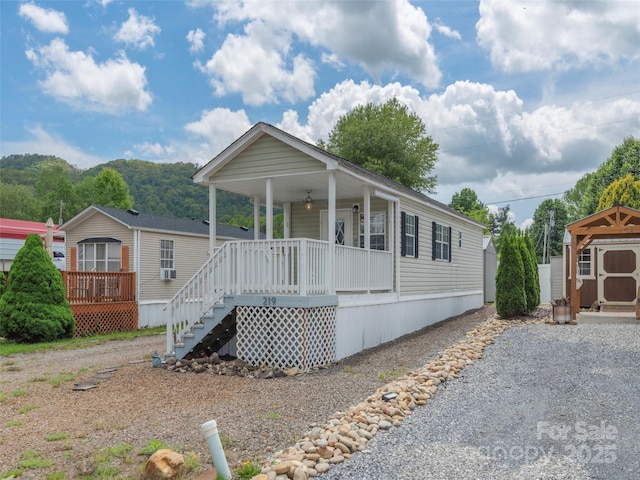 219 Pike Pt, Waynesville, NC 28785 - manufactured / mobile home with covered porch, stairs, a ceiling fan, and a shed