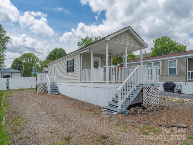 219 Pike Pt, Waynesville, NC 28785 - manufactured / mobile home featuring stairs, covered porch, and fence