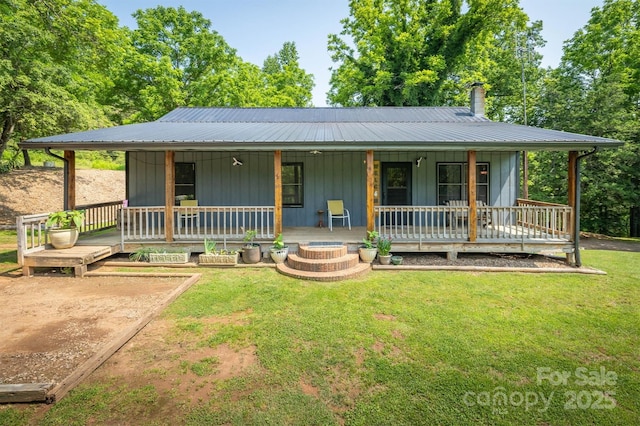 1533 Mcrary Creek Rd, Lenoir, NC 28645 - farmhouse-style home featuring a front yard, a porch, board and batten siding, and metal roof