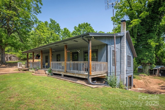 1533 Mcrary Creek Rd, Lenoir, NC 28645 - view of front of home with a porch, a front yard, a chimney, and an attached garage