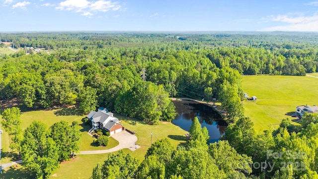 aerial view with a water view and a wooded view