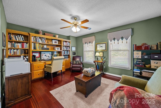 office area featuring a textured ceiling, ceiling fan, and dark wood-style floors