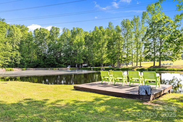 exterior space with a lawn and a deck with water view