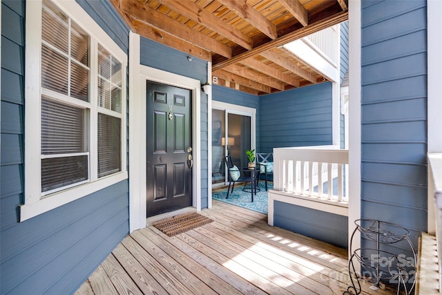 wooden terrace featuring covered porch