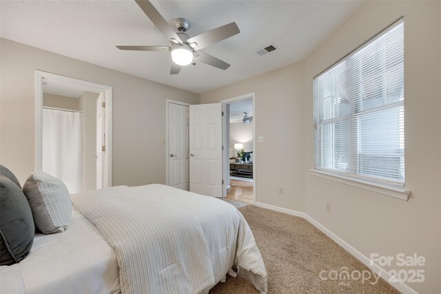 bedroom with light carpet, baseboards, and ceiling fan