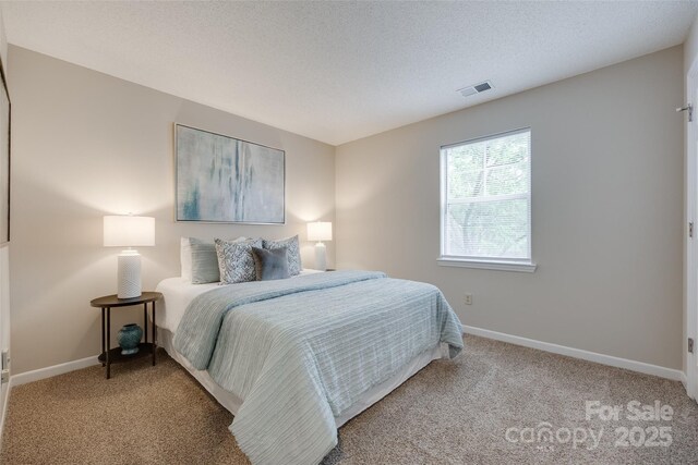carpeted bedroom featuring baseboards