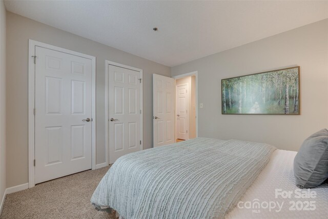 carpeted bedroom with baseboards