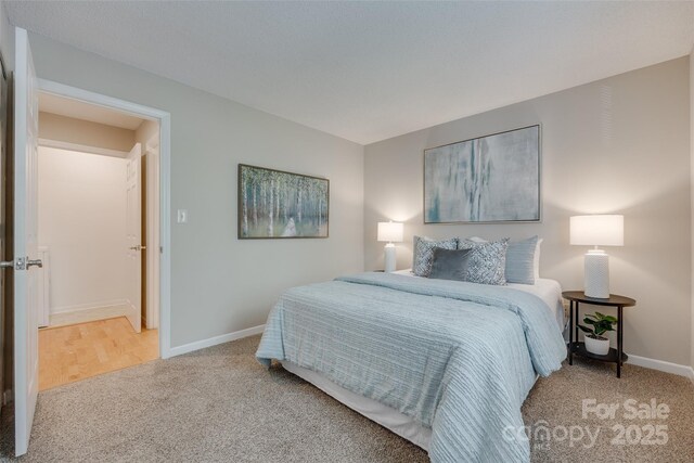 bedroom featuring carpet floors and baseboards