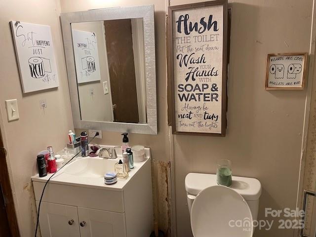 bathroom featuring vanity and toilet